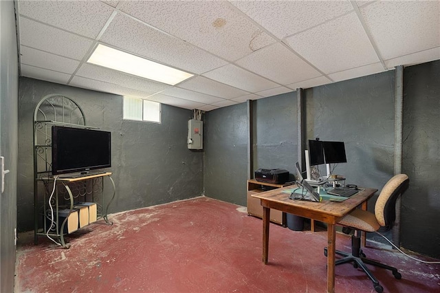 home office with a drop ceiling, electric panel, concrete flooring, and a textured wall