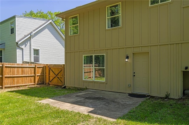 rear view of property featuring board and batten siding and a patio area
