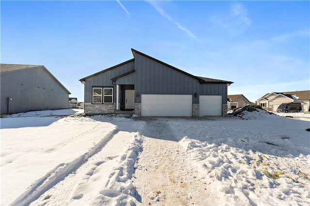 501 Woodview Dr, Raymore, MO 64083 - snow covered structure with an attached garage