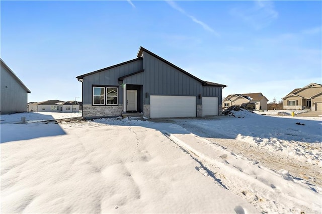 501 Woodview Dr, Raymore, MO 64083 - view of front of house featuring a garage, board and batten siding, and a residential view