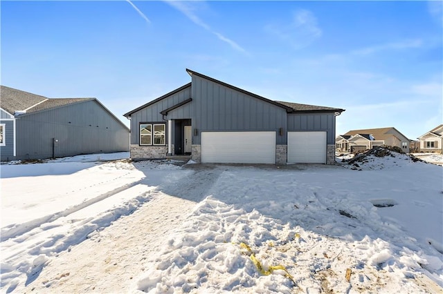 501 Woodview Dr, Raymore, MO 64083 - snow covered structure with a garage