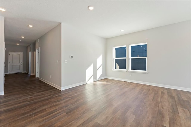 501 Woodview Dr, Raymore, MO 64083 - spare room with dark wood-type flooring, baseboards, and recessed lighting