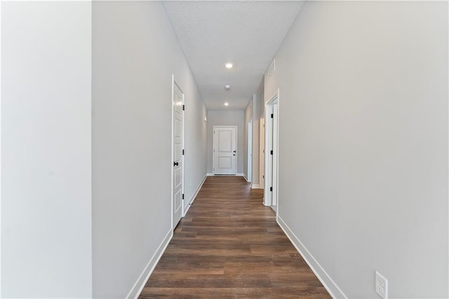 501 Woodview Dr, Raymore, MO 64083 - hall featuring baseboards, dark wood finished floors, and recessed lighting