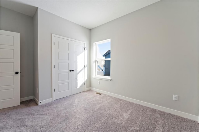 501 Woodview Dr, Raymore, MO 64083 - unfurnished bedroom featuring carpet flooring, baseboards, and a closet