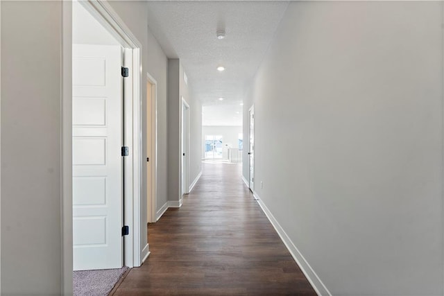 501 Woodview Dr, Raymore, MO 64083 - hall featuring baseboards, dark wood-type flooring, and recessed lighting