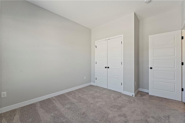 501 Woodview Dr, Raymore, MO 64083 - unfurnished bedroom featuring carpet flooring, baseboards, and a closet