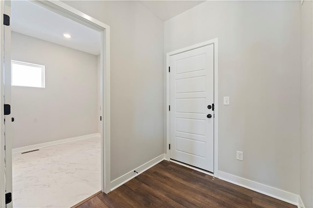501 Woodview Dr, Raymore, MO 64083 - foyer with baseboards, dark wood-type flooring, and recessed lighting