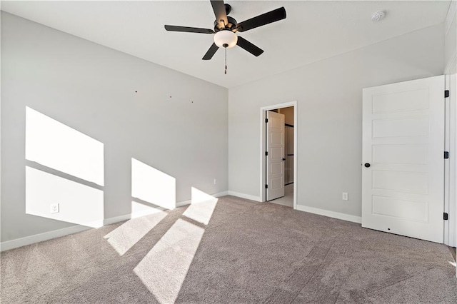 501 Woodview Dr, Raymore, MO 64083 - unfurnished bedroom featuring carpet floors, baseboards, and a ceiling fan