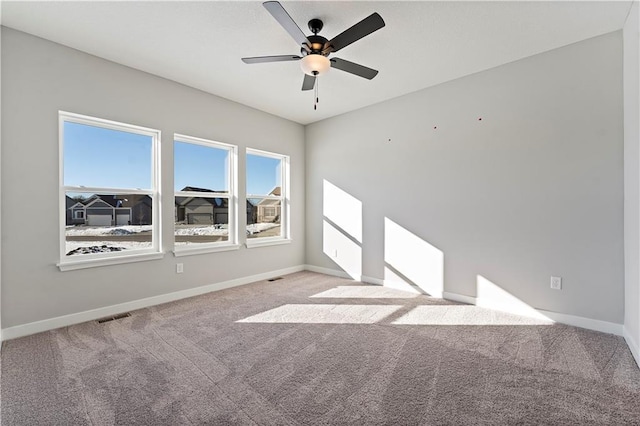 501 Woodview Dr, Raymore, MO 64083 - carpeted empty room featuring baseboards and a ceiling fan