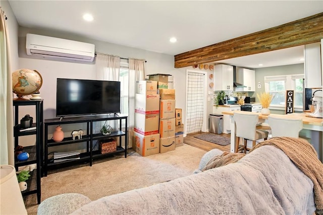 living room with an AC wall unit, recessed lighting, beamed ceiling, and light colored carpet