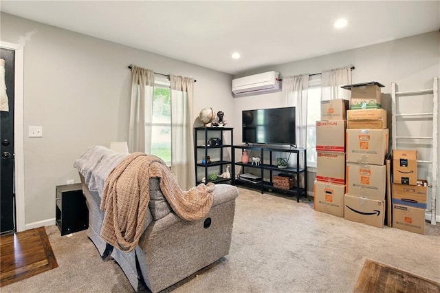 living area with a wall mounted air conditioner, carpet floors, and recessed lighting