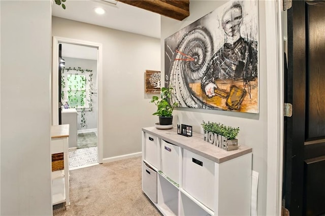 hall featuring light colored carpet, baseboards, and recessed lighting