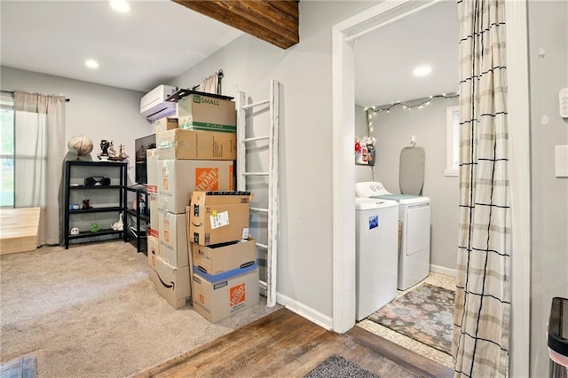 storage featuring washing machine and clothes dryer and a wall unit AC