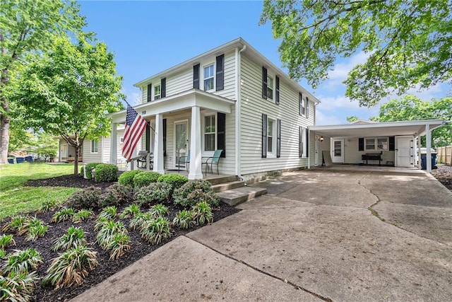 traditional style home featuring a porch, concrete driveway, and an attached carport