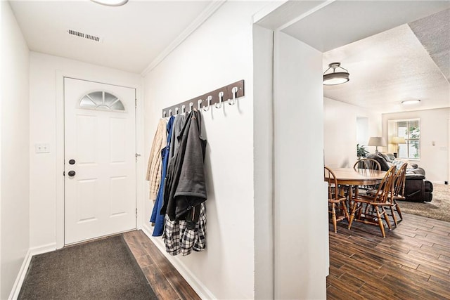 mudroom featuring dark wood finished floors and baseboards