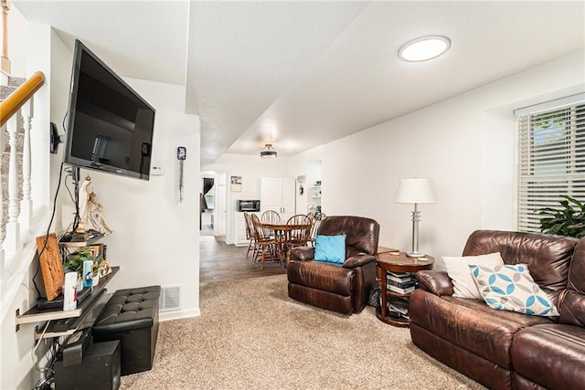 living room featuring carpet floors and baseboards