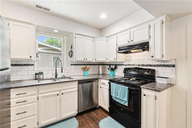 kitchen with appliances with stainless steel finishes, a sink, under cabinet range hood, dark wood finished floors, and white cabinets