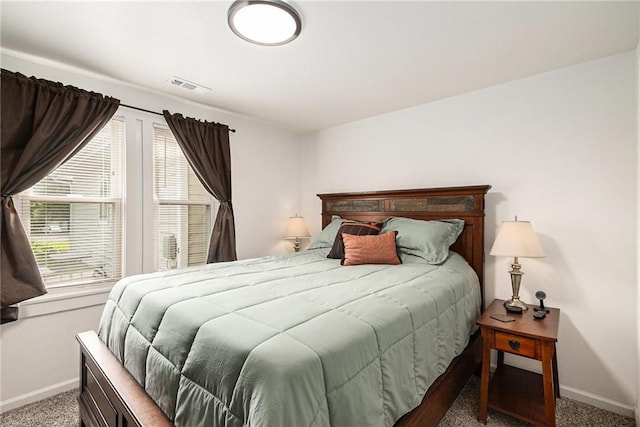 carpeted bedroom featuring baseboards