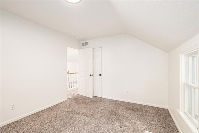 bonus room with lofted ceiling, carpet floors, and baseboards