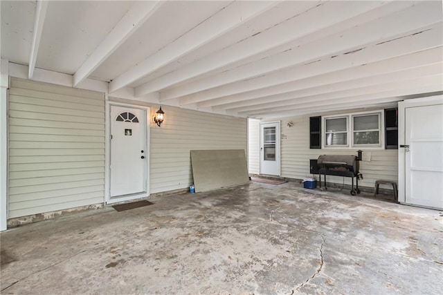 property entrance featuring a patio area and a carport