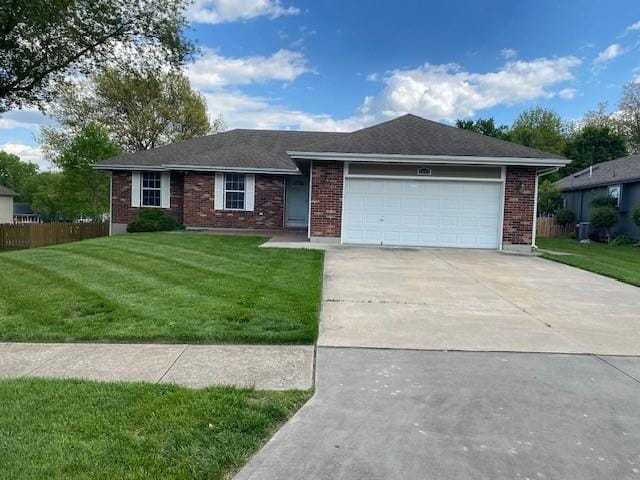 single story home with a garage, driveway, and brick siding