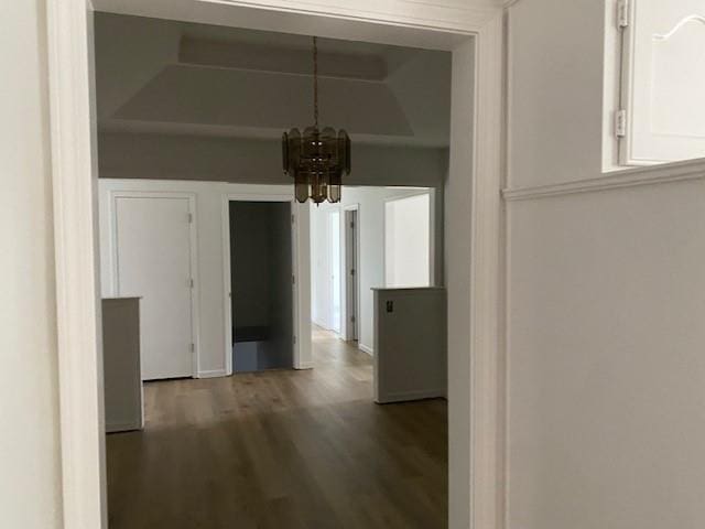 hall with a chandelier and wood finished floors