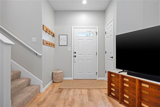 entrance foyer featuring light wood-type flooring, stairs, baseboards, and recessed lighting