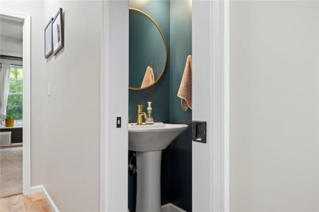 bathroom with baseboards and wood finished floors
