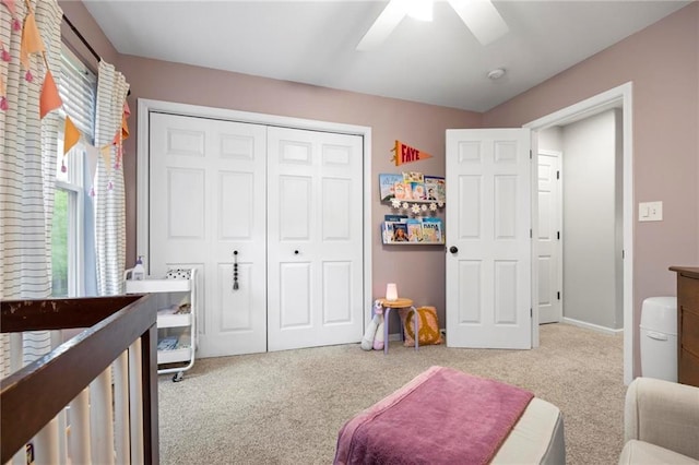 carpeted bedroom with a closet, a ceiling fan, and baseboards