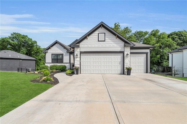 18235 NW 127th St, Platte City, MO 64079 - view of front facade with stone siding, a front lawn, driveway, and an attached garage