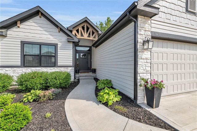 18235 NW 127th St, Platte City, MO 64079 - view of exterior entry with stone siding and a garage