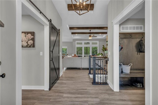 18235 NW 127th St, Platte City, MO 64079 - entryway featuring a barn door, wood finished floors, beamed ceiling, baseboards, and a ceiling fan