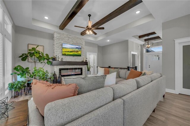18235 NW 127th St, Platte City, MO 64079 - living area with a tray ceiling, a fireplace, wood finished floors, beamed ceiling, and recessed lighting