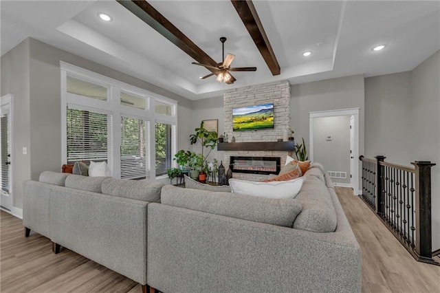 18235 NW 127th St, Platte City, MO 64079 - living area featuring a ceiling fan, light wood-style floors, a raised ceiling, a stone fireplace, and recessed lighting