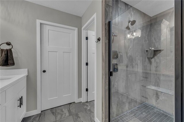 18235 NW 127th St, Platte City, MO 64079 - bathroom featuring a shower stall, marble finish flooring, baseboards, and vanity