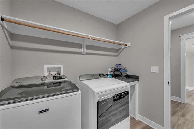 18235 NW 127th St, Platte City, MO 64079 - washroom with independent washer and dryer, light wood-style flooring, and baseboards