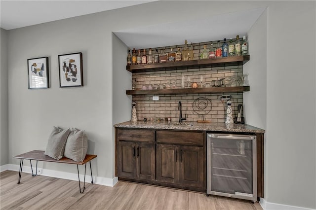 18235 NW 127th St, Platte City, MO 64079 - indoor wet bar with beverage cooler, light wood-style floors, and baseboards