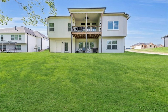 18235 NW 127th St, Platte City, MO 64079 - back of house featuring a ceiling fan, a balcony, and a yard