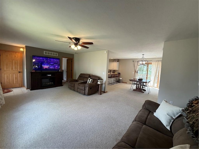 727 Serenity Loop, Maryville, MO 64468 - living area featuring light carpet, a chandelier, and a ceiling fan