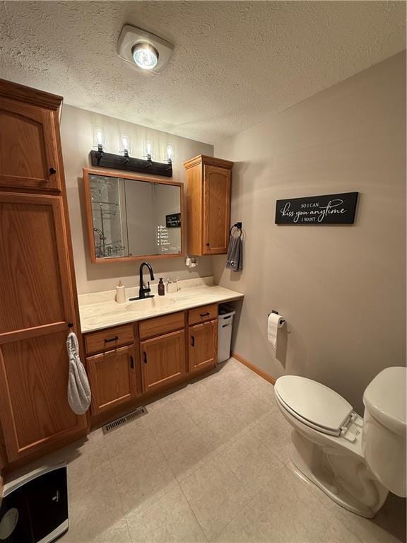727 Serenity Loop, Maryville, MO 64468 - bathroom featuring toilet, baseboards, vanity, and a textured ceiling