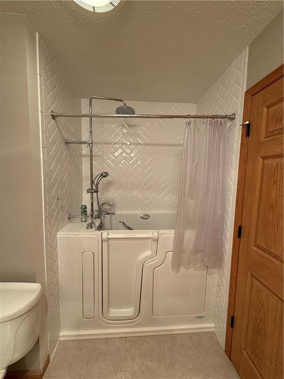 727 Serenity Loop, Maryville, MO 64468 - full bath featuring a shower with shower curtain, a bath, a textured ceiling, toilet, and tile patterned flooring