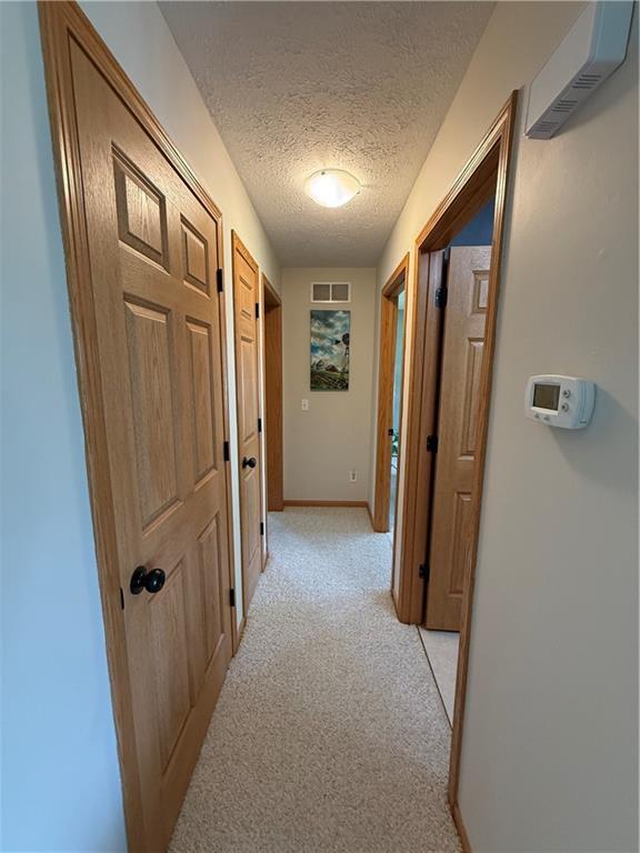 727 Serenity Loop, Maryville, MO 64468 - hall with a textured ceiling and light carpet