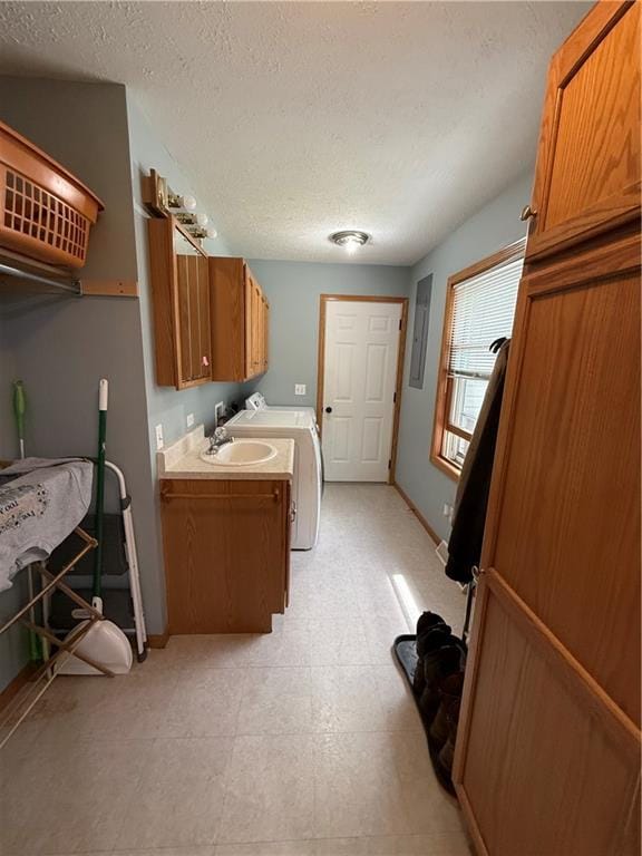 727 Serenity Loop, Maryville, MO 64468 - clothes washing area featuring cabinet space, a textured ceiling, baseboards, and washer and clothes dryer