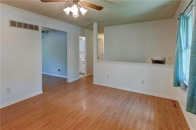 unfurnished room featuring ceiling fan, wood finished floors, and baseboards