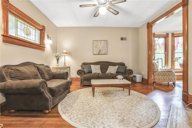 living room with ceiling fan, hardwood / wood-style floors, and baseboards