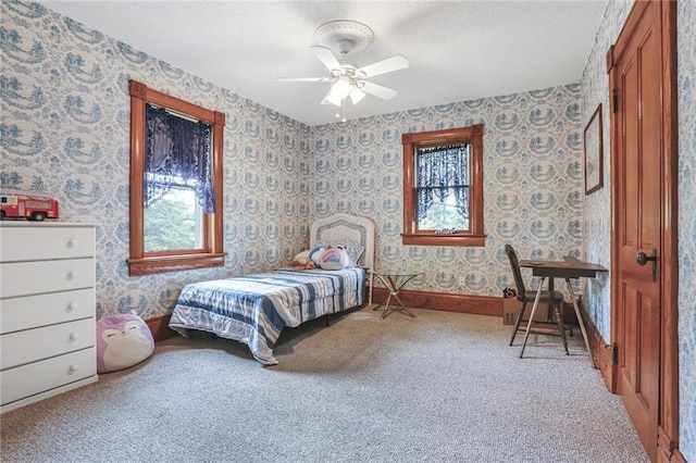 bedroom featuring carpet, wallpapered walls, a textured ceiling, and a ceiling fan