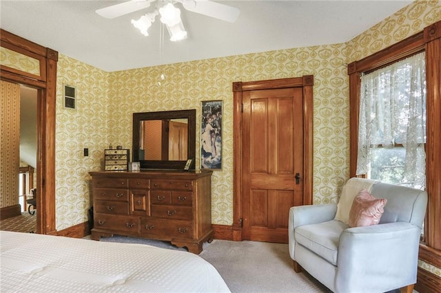 bedroom with wallpapered walls, baseboards, carpet flooring, and a ceiling fan