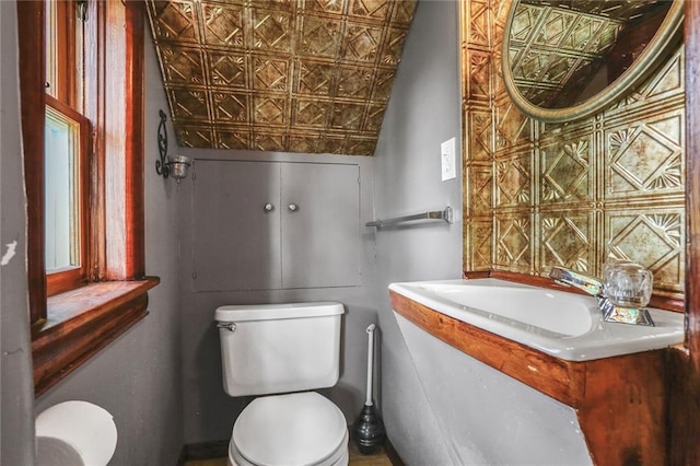 bathroom featuring toilet, an ornate ceiling, and vanity