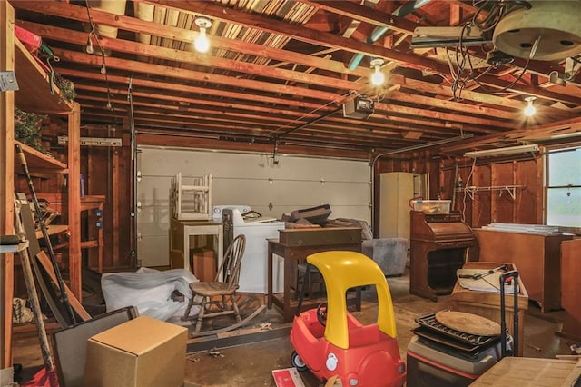 garage with a garage door opener and washer / clothes dryer