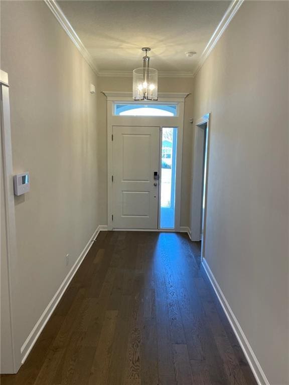 10617 N Fisk Ave, Kansas City, MO 64154 - foyer with a chandelier, dark wood-style flooring, baseboards, and crown molding